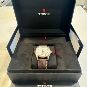 Tudor Timepiece with Silver Dial and Brown Strap